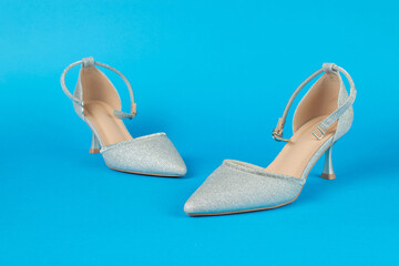 Elegant Silver High Heels on Vibrant Blue Background for Fashion and Style Concepts