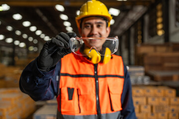Close up technician engineer wearing and adjust protective safety glasses. Safety equipment for...