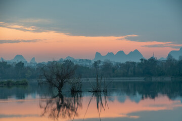 Golden Dawn on Li River: Misty Karst Peaks Reflecting in Mirror-Still Waters &ndash; Guilin's Ethereal Morning Symphony