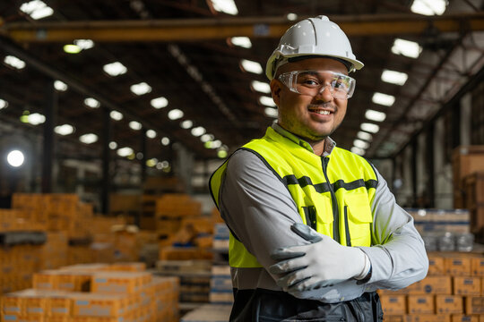 Close up technician engineer wearing and adjust protective safety helmet or hard hat. Safety equipment for industry factory. Safety at work concept.