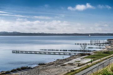 Serene Coastal Landscape With Calm Waters and Green Hillside Pathway, Fredericia, Denmark