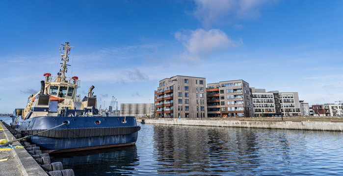 Harborfront Scene with Tugboat and Modern Residential Buildings on a Sunny Day, Fredericia, Denmark
