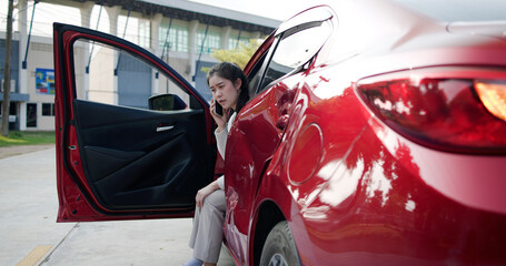 Disappointed woman watching her car get damaged due to an accident. A female driver was involved in a car accident and needed help with insurance and roadside assistance. It was an emergency situation