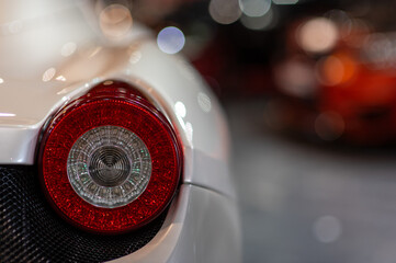 Old round red headlight close up view, front light details white retro car