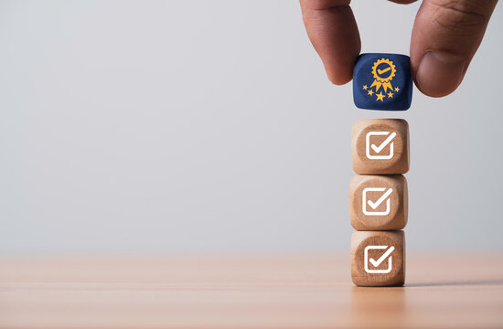 Hand putting the best quality assurance with golden five stars on correct sign mark for guarantee product and ISO service concept.