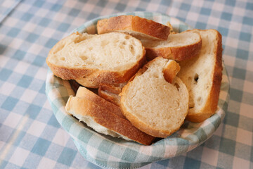 Freshly sliced bread served in a basket during a meal gathering
