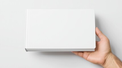 Obraz premium Elegant hardcover book mockup, showcased in a floating position, features a pristine white backdrop, angled view, and subtle shadows enhancing its three-dimensional effect.