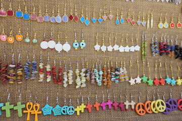 Colorful handmade earrings displayed at an artisan market in spring