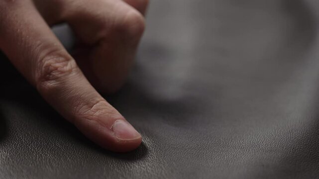 Slide shot man touching fine leather closeup