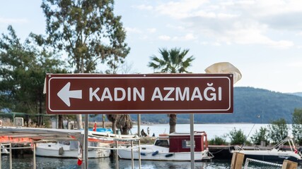 Directional sign pointing to Azmak River in Akyaka, Mugla, Turkey. A scenic spot known for its crystal-clear waters and boat tours, flowing into the Mediterranean.