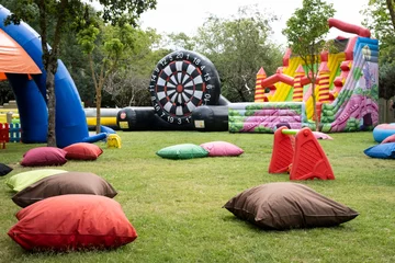 A relaxing space playground with large pillows and inflatables over grassy area. A fun playground for kids and their parents. © CanYalicn