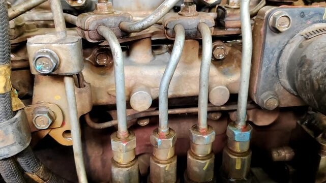 A detailed view of a mechanical truck car engine component featuring an injector system with attached pipes and engine parts, emphasizing engineering and technical design.
