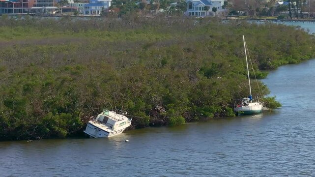 Capsized yachts left forsaken on shore after hurricane Milton on Manasota Key in Englewood, Florida.