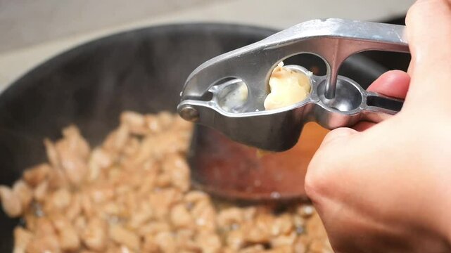 Cooking with fresh garlic while preparing chicken in the kitchen
