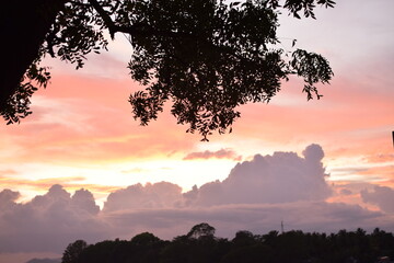 On a lake embankment at sunset. nature with lake landscape on sunset time. Cloudy Sunsets Over Lake in Summer. chandrika lake, Embilipitiya, Sri Lanka. Golden Sunset Reflections on Lake’s Tranquil