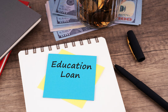 Education loan concept with a notebook, pen, currency banknotes, and a colorful sticky note labeled education loan, representing student financing, tuition expenses, financial assistance, and educatio
