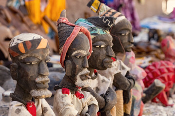 Wooden african figurines for sale on the market in Joal Fadiuth in Senegal