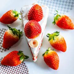 A top-down view of a slice of cake adorned with strawberries.