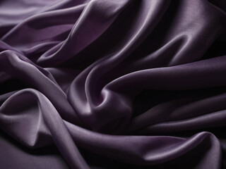 Fototapeta premium The purple silk fabric has a delicate, flowing texture.