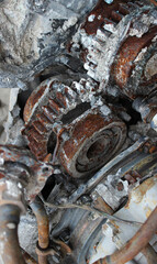 Fototapeta premium The moving parts of the old engine are covered with rust and oxide. The old engine has been standing outside for a long time 