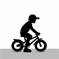 Fototapeta premium Silhouette of a child riding a bicycle in profile on a light background