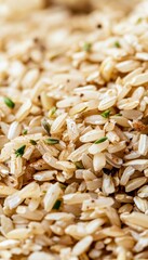 Close up image of nutritious cooked brown rice and oats sprinkled with spices and herbs for texture