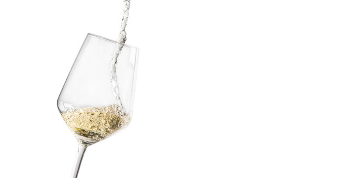 A close-up of white wine being poured into a glass, isolated on a white background. The splash and flow of the liquid capture a dynamic moment. - Powered by Adobe
