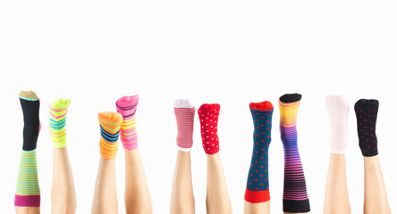 Down syndrome awareness, lost sock memorial day concept. Women legs with various colorful socks on feet in white background with copy space