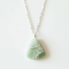 Elegant jade pendant necklace on a delicate chain.