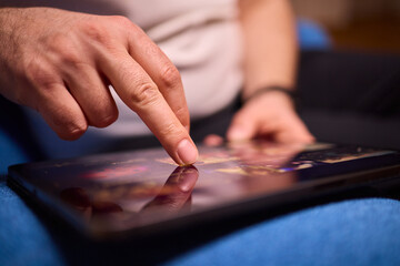 User Engaging with a Touchscreen Device While Relaxing in a Cozy and Inviting Setting