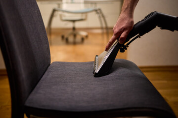 Using a Vacuum Cleaner for Upholstery Cleaning in a Modern Interior Design Setting
