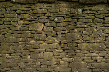 Stone wall, composed of irregularly shaped stones stacked 7