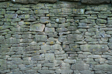 Stone wall, composed of irregularly shaped stones stacked 8