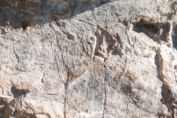 Rock surface covered in graffiti, markings, and natural discolorations 6