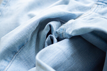 Old denim blue jeans fabric texture background close up
