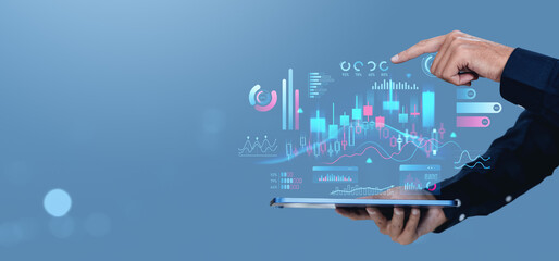 Businessman analyzing financial data on digital tablet.