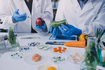 Team Asian scientists in a lab conducting food research using a microscope and lab equipment, showcasing innovation in food science and biotechnology