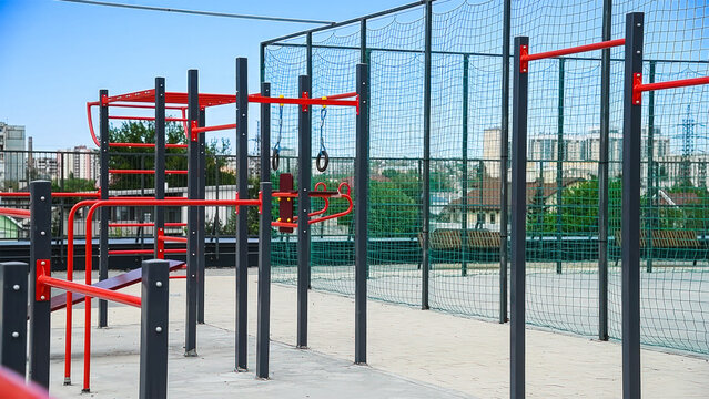 Sports ground with horizontal bars and other new exercise equipment in open air sport zone in the city