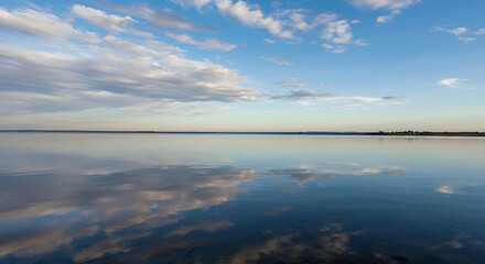 Obraz premium Tranquil Lake Reflection Under a Vast Blue Sky