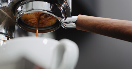 Pour espresso with bottomless portafilter low angle