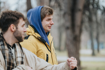 Two friends are seen laughing and interacting outdoors, showcasing a warm and joyous moment of...