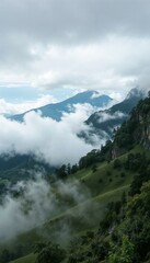 Scenic mountain landscape shrouded in clouds, showcasing rolling hills and lush greenery