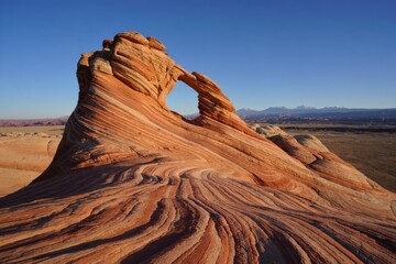 Layered sandstone rock formation with cave opening