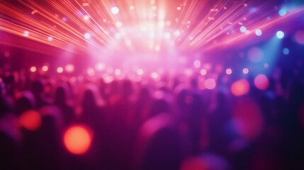 A vibrant concert scene featuring blurred silhouettes of a crowd enjoying dazzling light displays, ideal for music and nightlife themes.