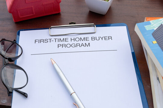 A first-time homebuyer loan assistance document is neatly placed on a desk, emphasizing financial planning for purchasing a new home.