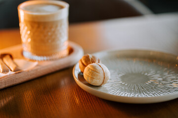 Delicious coffee with delicate pastries on a wooden table in a cozy cafe setting