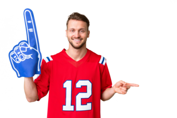 Young caucasian sports fan man over isolated chroma key background surprised and pointing finger to the side
