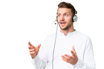 Telemarketer caucasian man working with a headset over isolated chroma key background with surprise facial expression