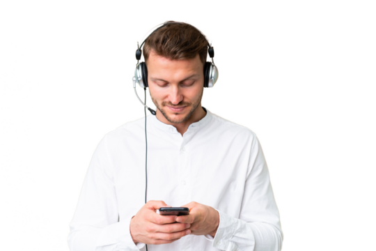 Telemarketer caucasian man working with a headset over isolated chroma key background sending a message with the mobile