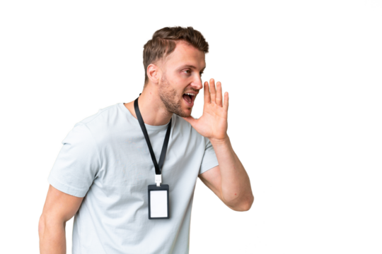 Young caucasian man with ID card over isolated chroma key background shouting with mouth wide open to the side